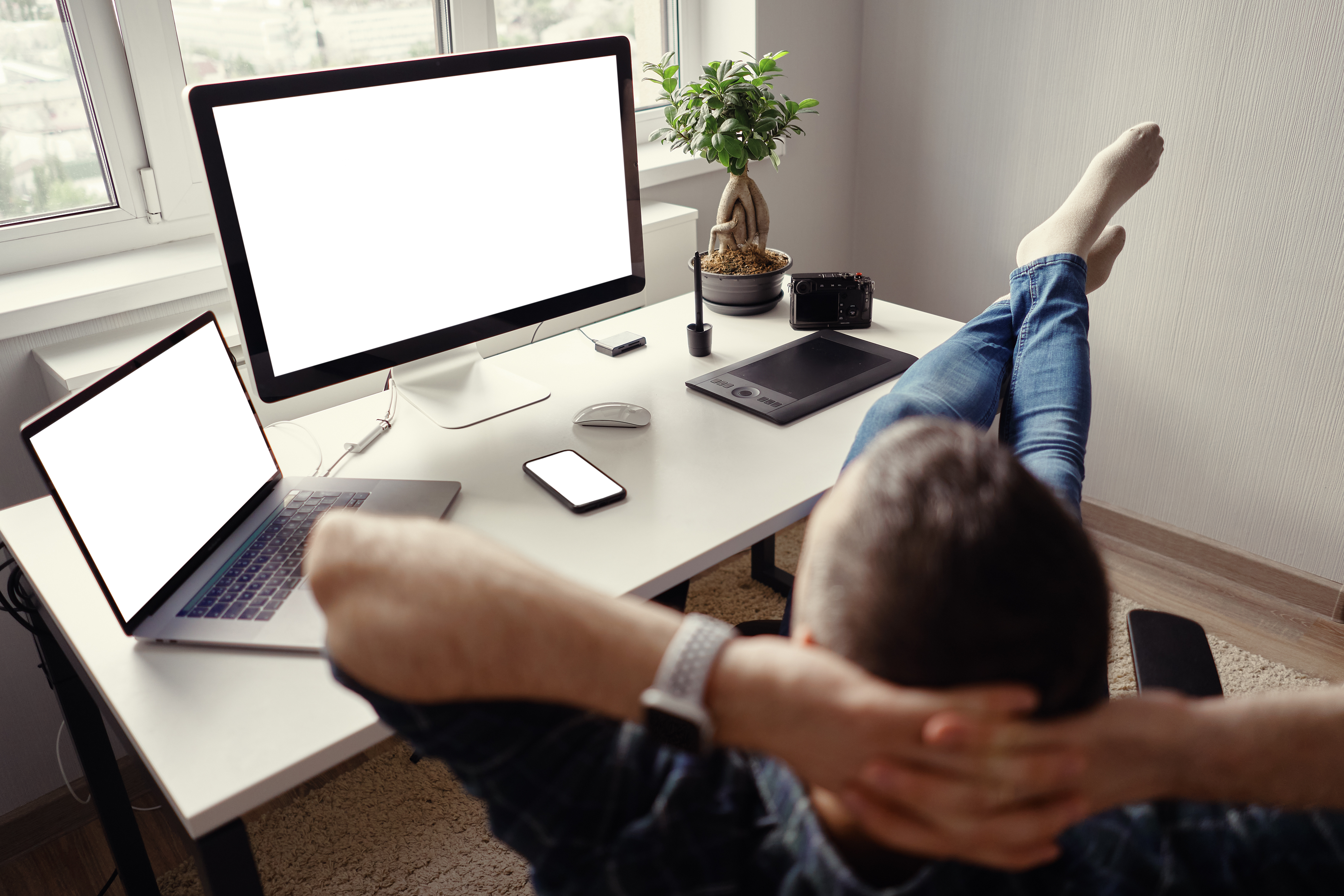 modern man in home office relaxing with legs on the table